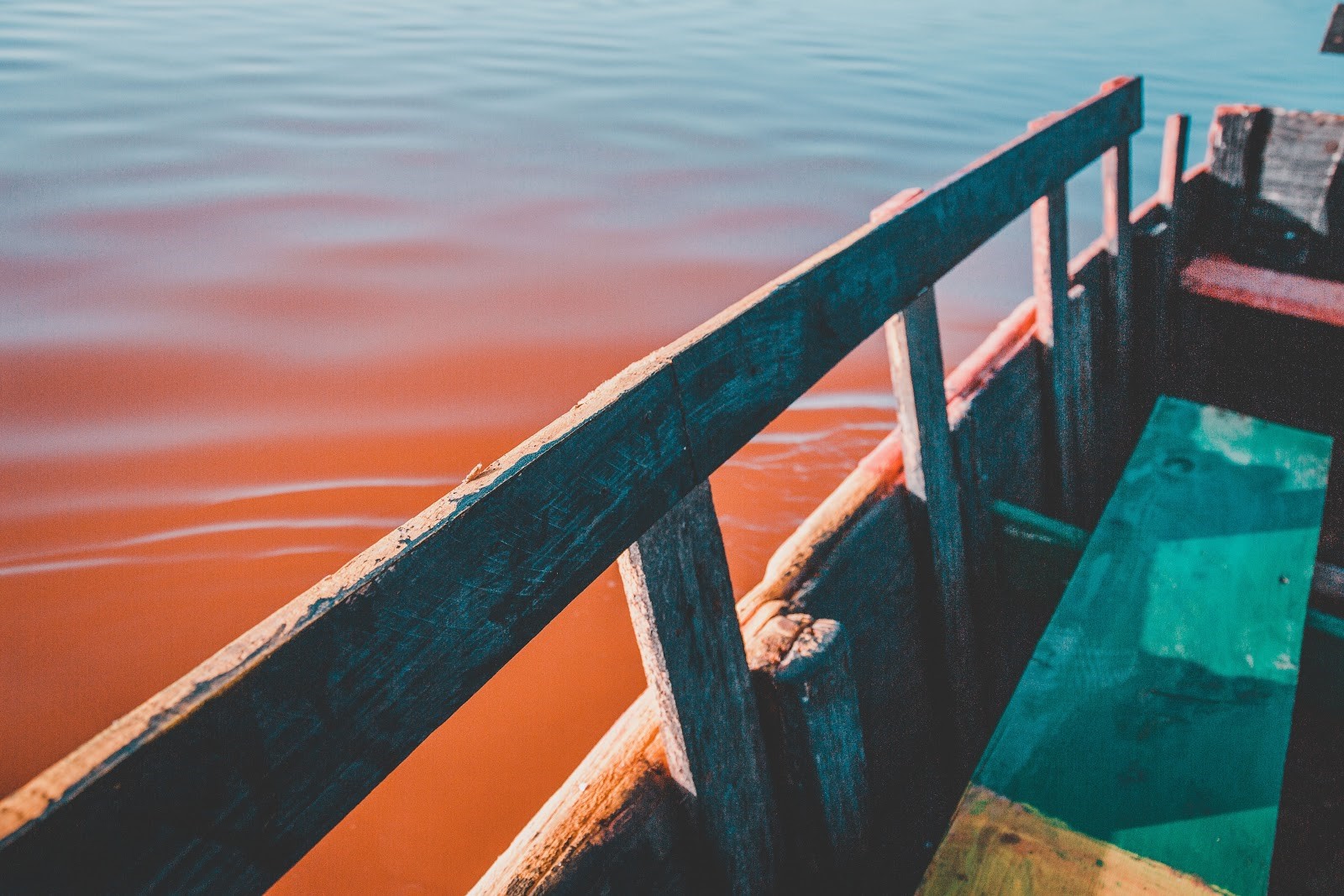 houten bootje op de zee met rode schijn